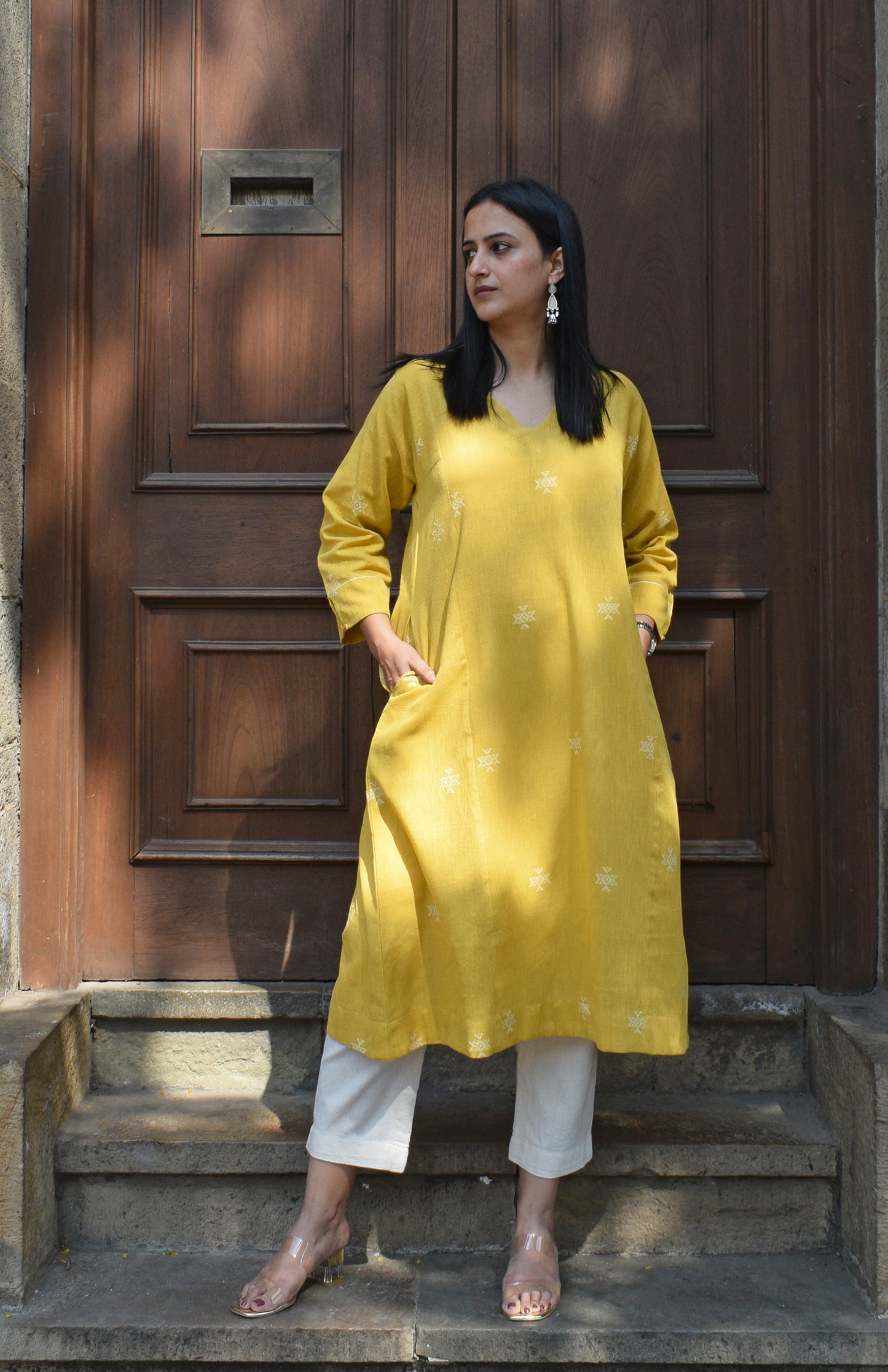 Yellow A line kala cotton kurta with V neck and ivory trousers